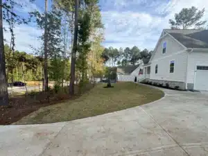 Front yard of a new construction home featuring lush, newly installed Bermuda sod for a vibrant lawn.