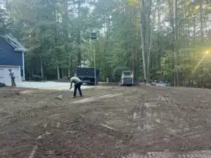 MWM Landscaping & Grading team leveling and grading a Raleigh yard, preparing for hydroseeding and improved drainage.