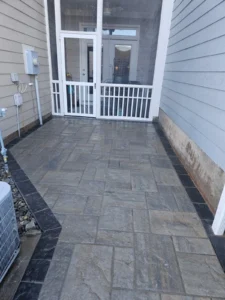 Techo-Bloc Slate Champagne Grey pavers with black border create a clean, mud-free walkway in Cary, NC – installed by MWM Landscaping with perfect drainage.