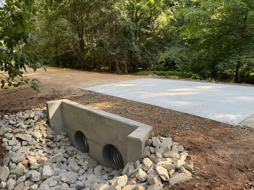 New concrete culvert headwall with rip rap and concrete road apron completed on Fern Creek Trail in Pittsboro