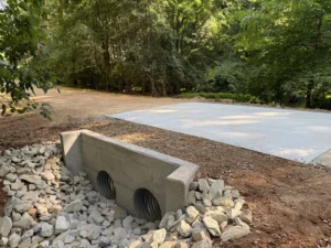 New concrete culvert headwall with rip rap and concrete road apron completed on Fern Creek Trail in Pittsboro